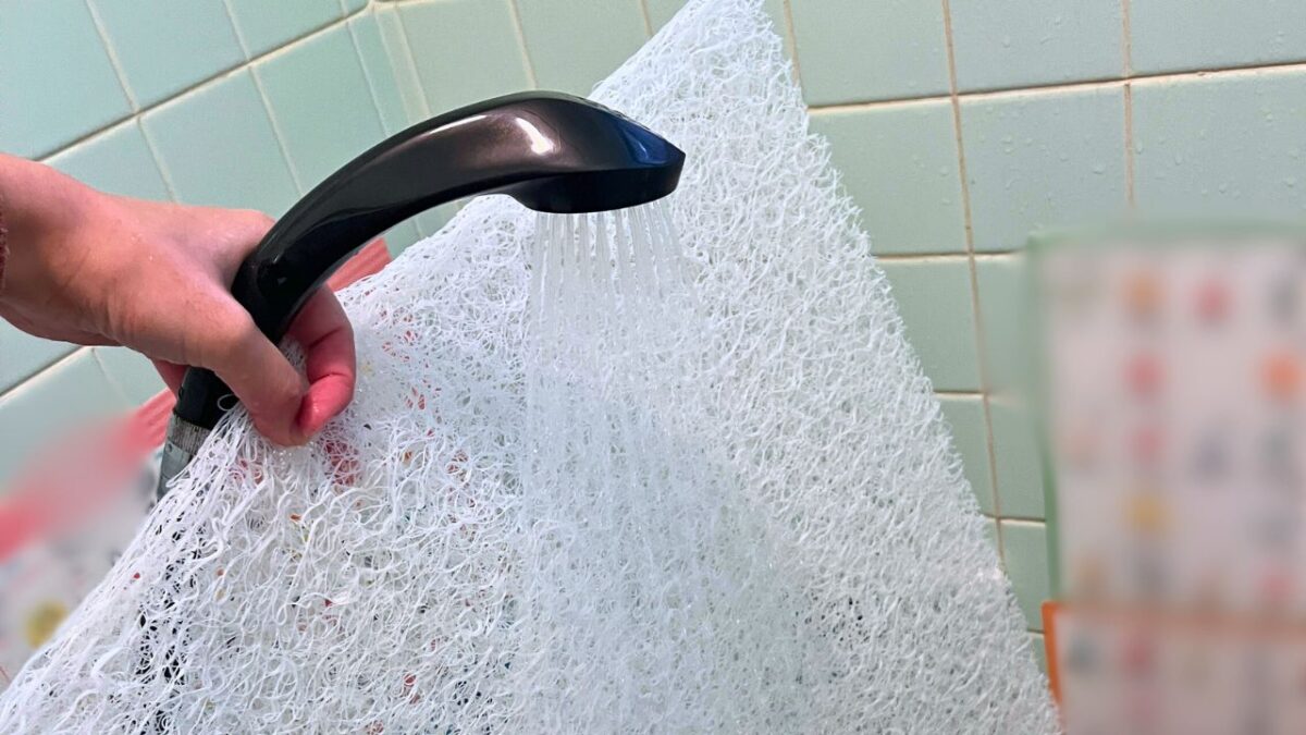 自宅の浴室で中芯をシャワーで軽々と洗う様子。